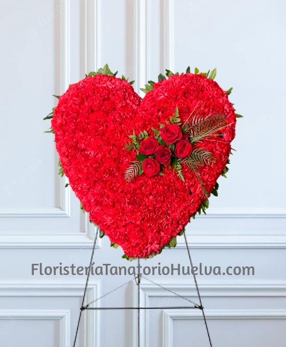 Corazón de flores fúnebres rojo